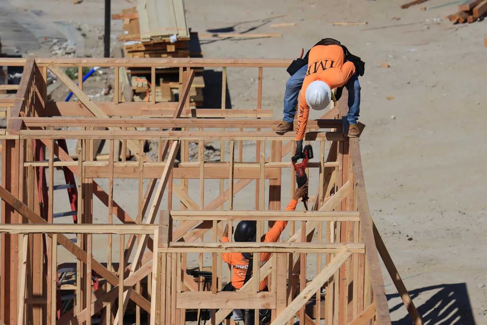Contractor crew framing a wood-frame house
